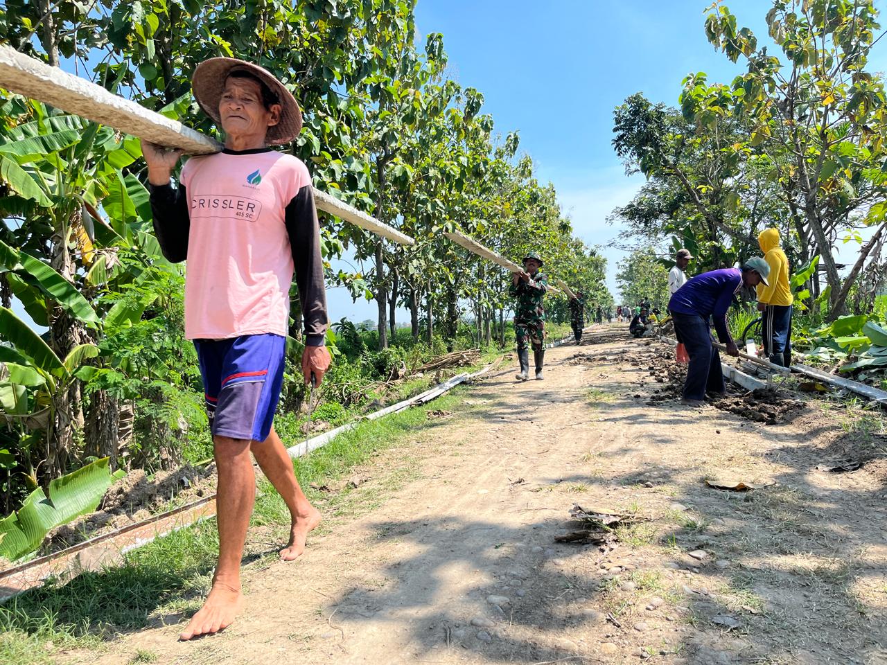 Satgas TMMD Bersama Warga Melangsir Begesting Besi Untuk Betonisasi Jalan